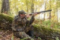 Hunter with a gun in the autumn woods Royalty Free Stock Photo