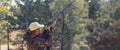 Hunter with a hat and a gun in search of prey in the steppe, Aims for prey.