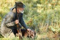 Hunter and his dog looking for trophy in forest Royalty Free Stock Photo