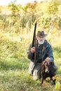 Hunter and his dog looking for trophy in forest Royalty Free Stock Photo