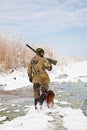 Hunter with his hunting dog during a winter hunt Royalty Free Stock Photo