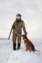 Hunter and his hunting dog in winter open season Royalty Free Stock Photo