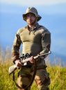 Hunter hold rifle. Hunter mountains landscape background. Focus and concentration experienced hunter. Ready to shoot Royalty Free Stock Photo