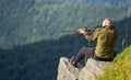 Hunter hold rifle. Hunter spend leisure hunting. Man brutal gamekeeper nature landscape background. Hunting in mountains