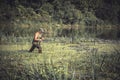 Hunter man breaking through swamp during hunting period Royalty Free Stock Photo