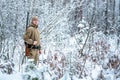 Hunter man dressed in camouflage clothing standing in the winter