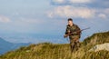 Hunter man. Shooter sighting in the target. Hunting period. Hunter is aiming. The man is on the hunt. Hunt hunting rifle Royalty Free Stock Photo