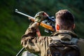 Hunter man. Shooter sighting in the target. Hunting period. Male with a gun. Close up. Hunter with hunting gun and Royalty Free Stock Photo