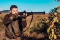 Hunter with Powerful Rifle with Scope Spotting Animals. Hunter with shotgun gun on hunt. Track down.