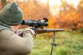 Hunter or ranger with a professional, nightvision hunting gun aiming wild animal and hunting form to hunt in an autumn Royalty Free Stock Photo