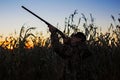 Hunter with rifle aiming at ducks