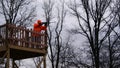 Hunter taking aim from an elevated stand Royalty Free Stock Photo