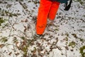 Hunter wearing orange trousers walking in forest