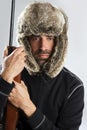 Hunter winter fur hat man holding gun Royalty Free Stock Photo