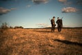 HunterS with shotgun gun on hunt. Calibers of hunting rifles. HunterS in camouflage clothes ready to hunt with hunting