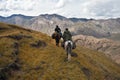 Hunters two horses returned with a trophy after a hunt Royalty Free Stock Photo