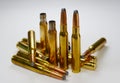 Hunting ammunition and empty rifle bullet cartridges on whitye. Royalty Free Stock Photo