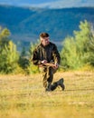 Hunting as male hobby and leisure. Hunter khaki clothes ready to hunt hold gun mountains background. Hunting shooting