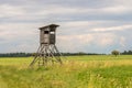 hunting blind on a field, in the background the sky with white clouds Royalty Free Stock Photo