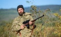 Hunting is brutal masculine hobby. Man aiming target nature background. Hunter hold rifle. Aiming skills. Hunting permit Royalty Free Stock Photo