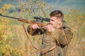 Hunting is brutal masculine hobby. Man aiming target nature background. Aiming skills. Hunter hold rifle. Hunting permit Royalty Free Stock Photo