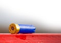 Hunting cartridge blue used lies on the red table
