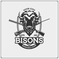 Hunting club emblem with bison and crossed rifles.