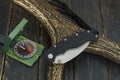 Hunting composition of a folded knife, a compass and a deer horn. Royalty Free Stock Photo