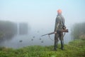 Hunting with ducks decoy on lake.