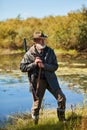 Handsome hunter near lake Royalty Free Stock Photo