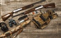 Hunting equipment on old wooden background including rifle, knife, binoculars and cartridges Royalty Free Stock Photo