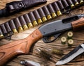 Pump action shotgun, 12 guage cartridge and hunting knife Royalty Free Stock Photo