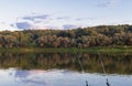 Hunting fishing on the river two fishing rods on the shore of the forest earlier morning Royalty Free Stock Photo