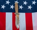 Hunting knife american flag flat lay on gray background. United States Gun Laws - Guns and weapons