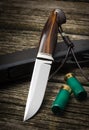 Hunting knife handmade on a brown wooden background. Leather Sheath Handmade.