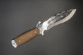 Hunting knife with teeth on gray background. knife barbs