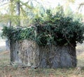 hunting lodge of hunters camouflaged with green leaves to hide Royalty Free Stock Photo