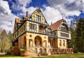 Hunting lodge under sky with clouds in the forest in yellow sands. Gelbensande, Germany Royalty Free Stock Photo