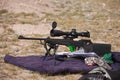 A hunting rifle with optical sight and bipod support,