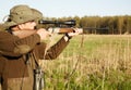 Hunting, rifle and target with a ranger man aiming a weapon on a field outdoor in nature for sport. Gun, scope and Royalty Free Stock Photo