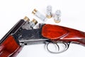 Hunting shotgun and ammunition on white background. Royalty Free Stock Photo