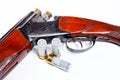 Hunting shotgun and ammunition on white background. Royalty Free Stock Photo