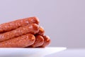 Hunting smoked sausage on a white plate closeup