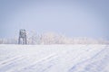 Hunting stand in agricultural field covered with snow Royalty Free Stock Photo