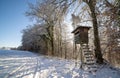Hunting tower at the edge of the winter forest Royalty Free Stock Photo