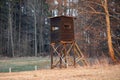 Hunting tower in wild forest. Wooden Hunter Hide High watch post tower. Hunter`s observation point in forest in Europe. Czech