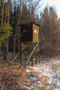 Hunting tower in wild forest. Wooden Hunter Hide High watch post tower. Hunter`s observation point in forest in Europe. Czech