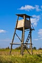 Hunting watchtower on a mountain meadow at sunny autumn afternoon