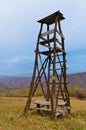 Hunting watchtower on a mountain meadow at sunset