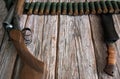 Hunting weapons, a knife in a case and a bandolier with cartridges on a wooden background.